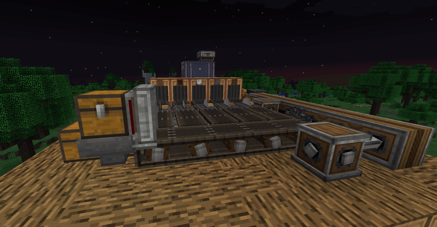 A working Create factory setup with belts, storage, and processing machinery at night.